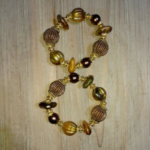 Pair of gold accented beaded stretch bracelets
